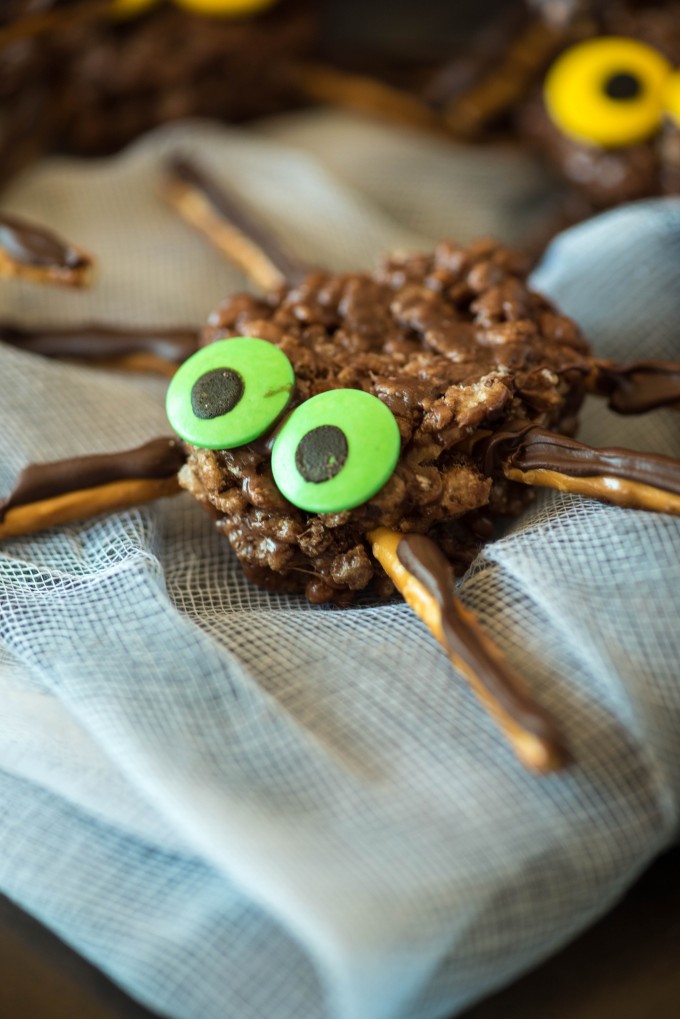 Chocolate peanut butter crispy treats spider with green eyes on a cloth