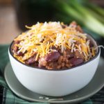 Instant pot chili topped with cheese in a white bowl